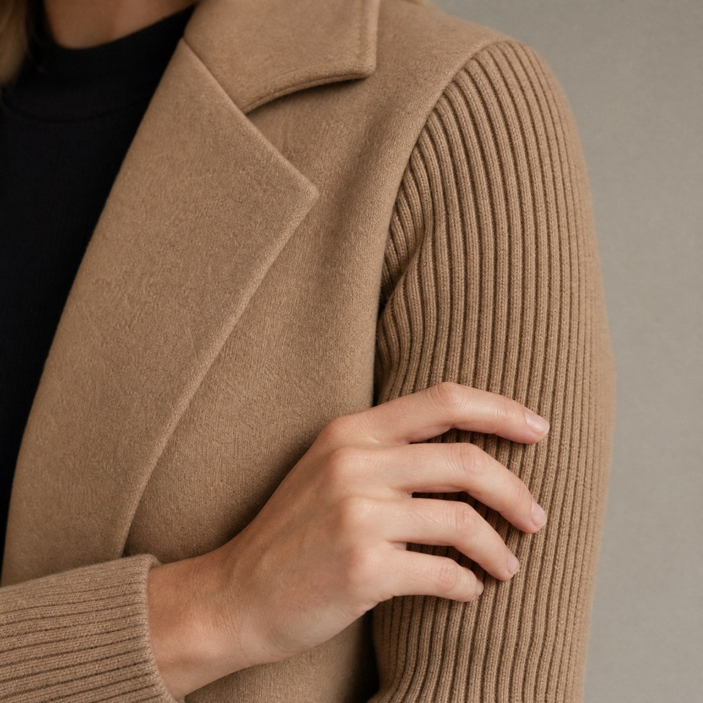 Close up of the woven body meeting the ribbed knit sleeve