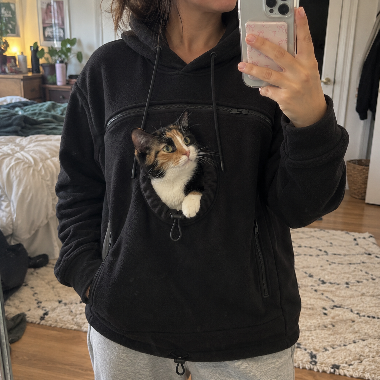 Black hoodie with a cat in the front pouch